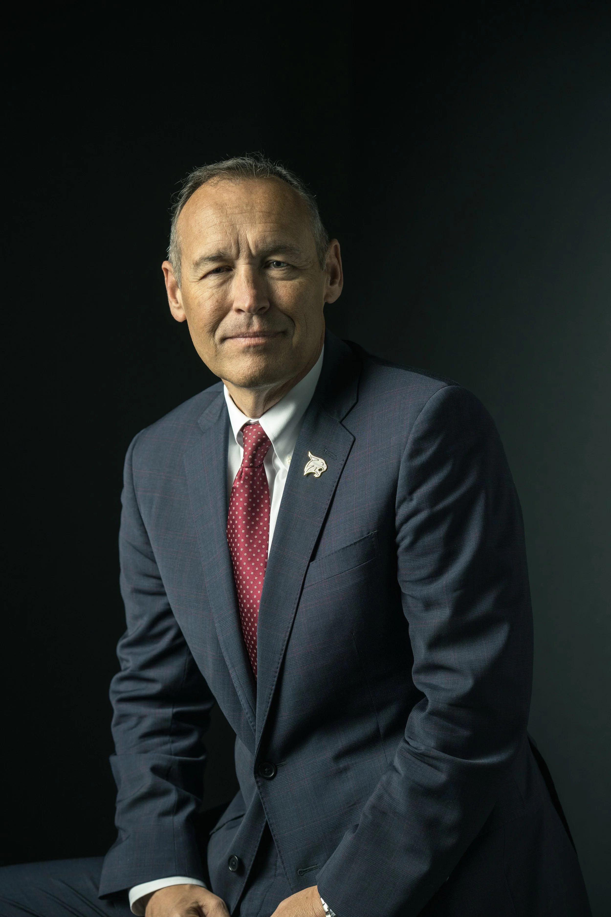 President Kelly Damphousse poses for a moody portrait.