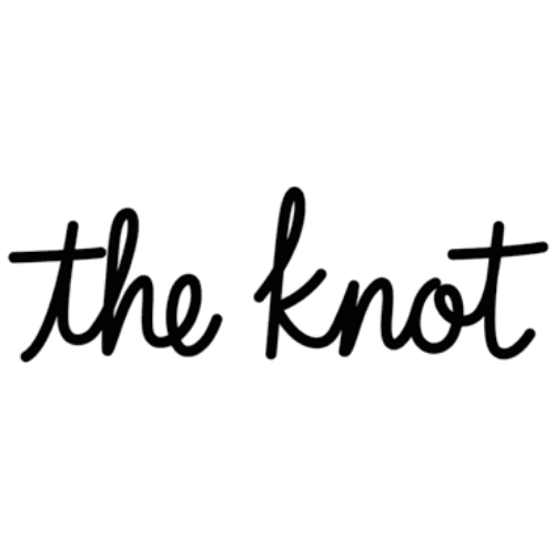 Silhouette of a person sitting on a dock, looking out at a body of water during sunset with the phrase 'the knot' in cursive overlayed.