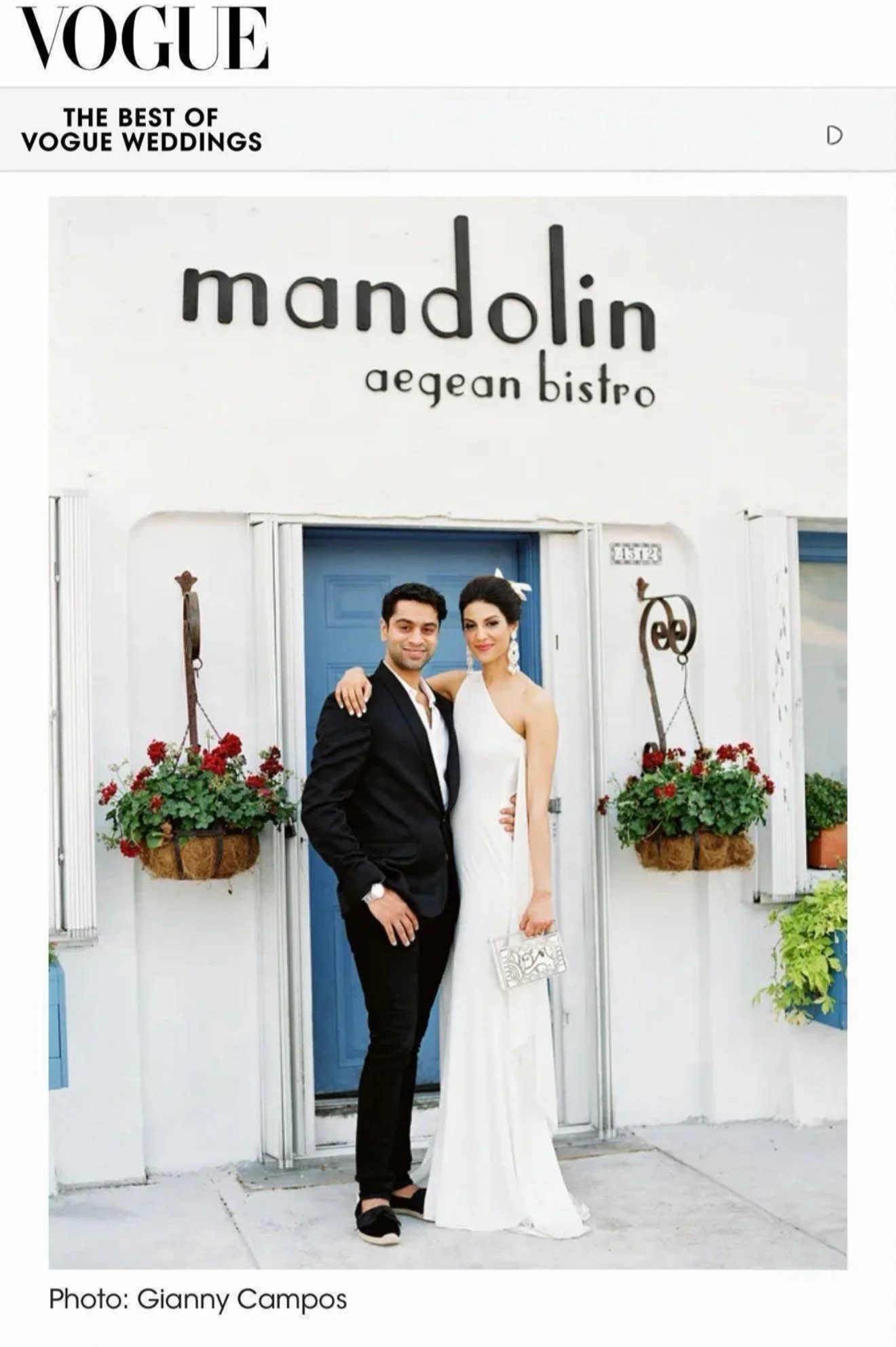 A bride and groom posing outside a restaurant called Mandolin Aegean Bistro, with potted plants and hanging flower baskets on a white wall, under a Vogue magazine cover header.