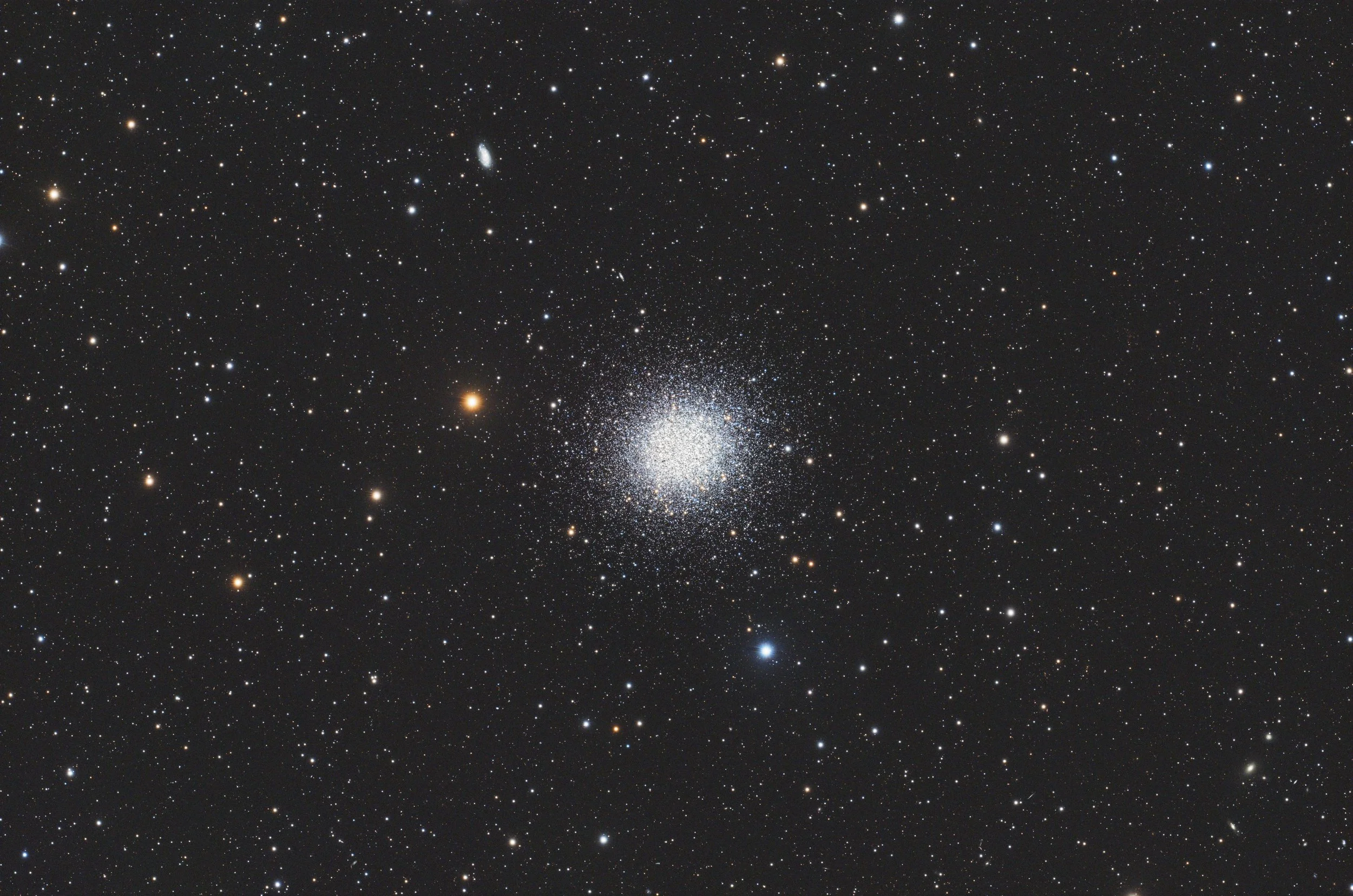 A detailed image of a dense star cluster in space with a wide range of star temperatures.