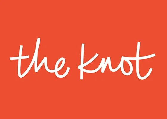 Logo with orange background and white handwritten text that says 'the knot'