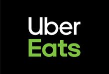 Uber Eats logo with white and green text on a black background.