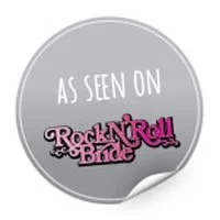 Circular badge with the text 'As Seen On Rock N Roll Bride' in white and pink on a gray background.