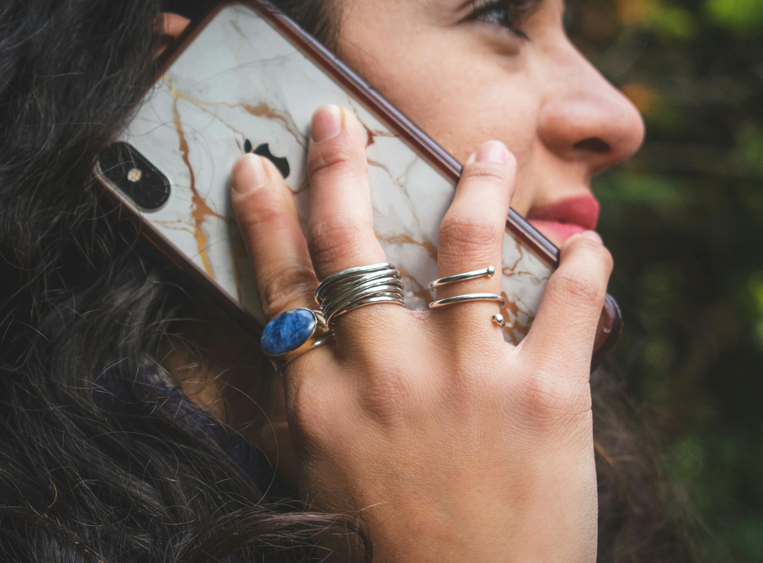 A woman talking and smiling on the phone. Psychologist in Utah. Therapy near me. Psychological evaluations near me. Evaluations for Autism in Utah.