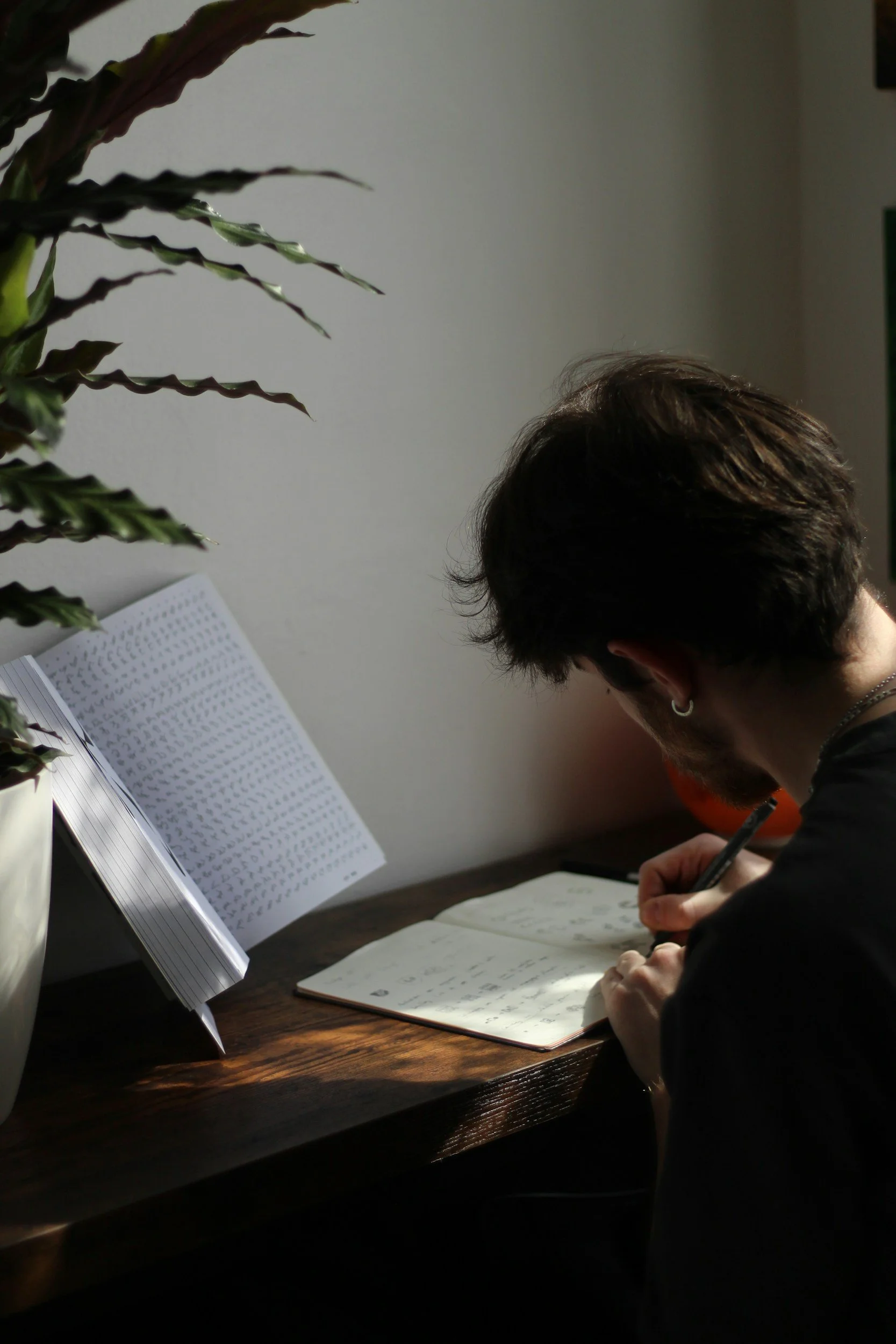 Teen boy doing homework, representing executive functioning, organization, and school challenges that teens with ADHD may experience.
