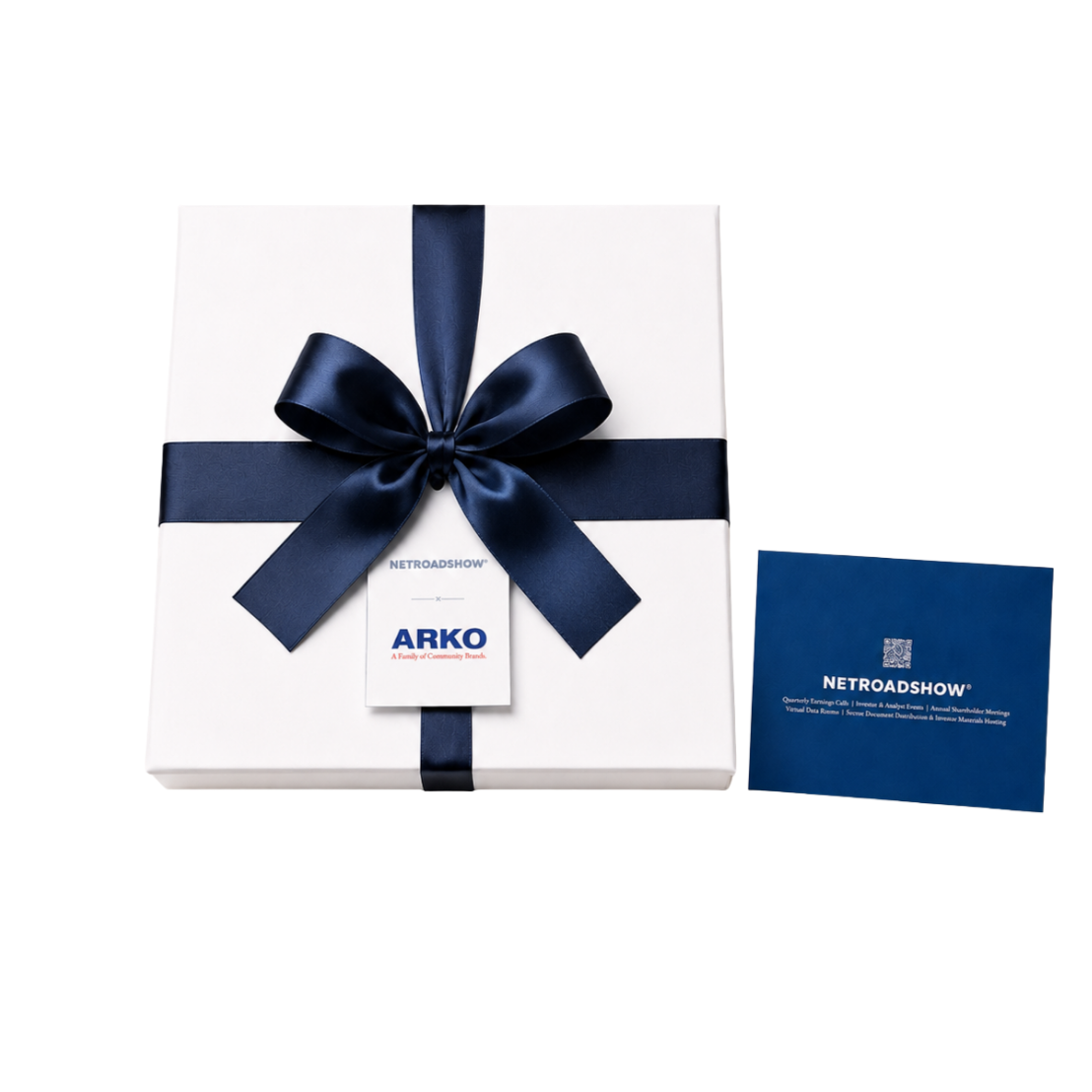 A white gift box wrapped with a navy blue satin ribbon tied in a bow, with a white tag from ARKO, and a dark blue informational card beside it.