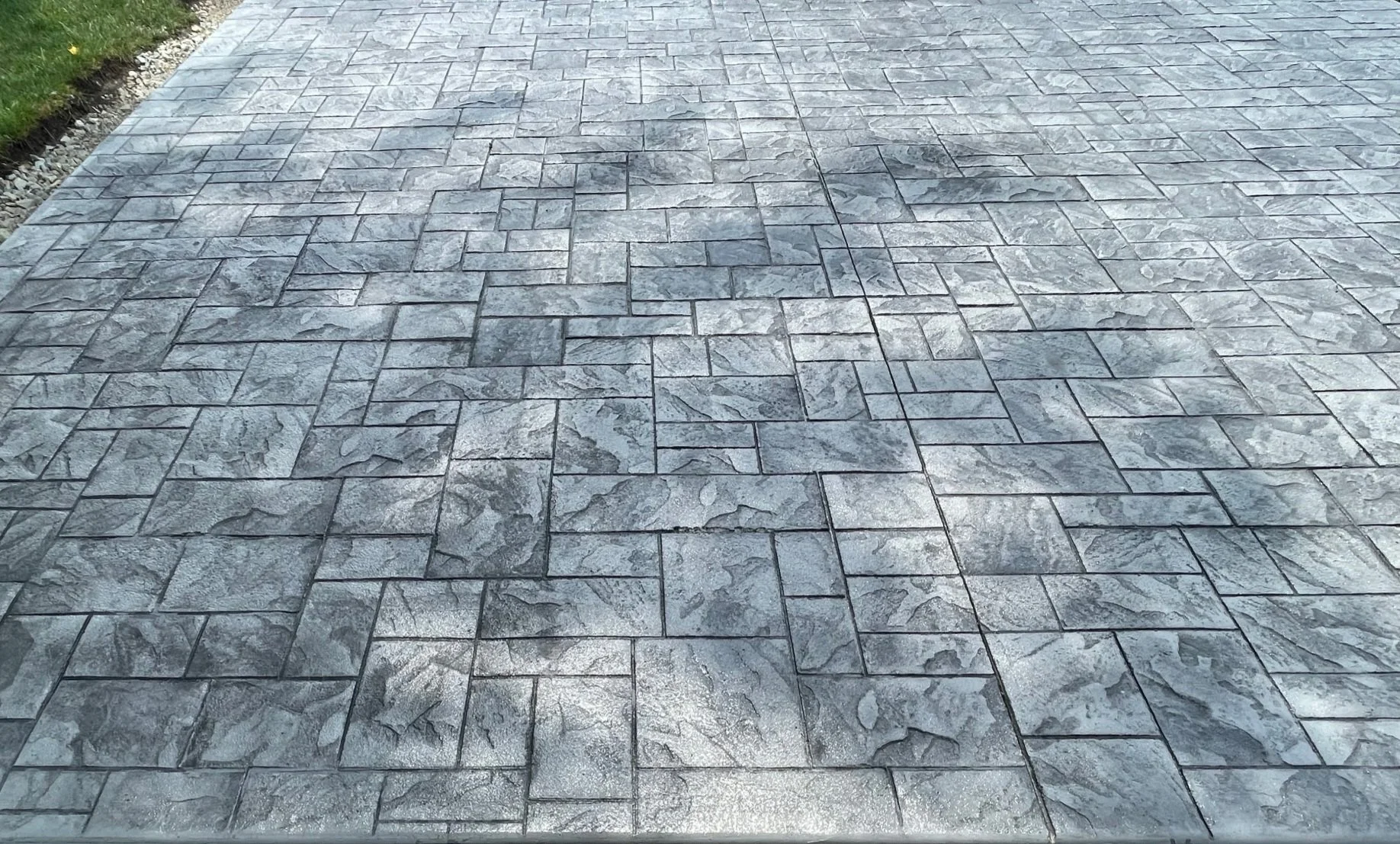 Gray interlocking stone paving on a sidewalk or driveway