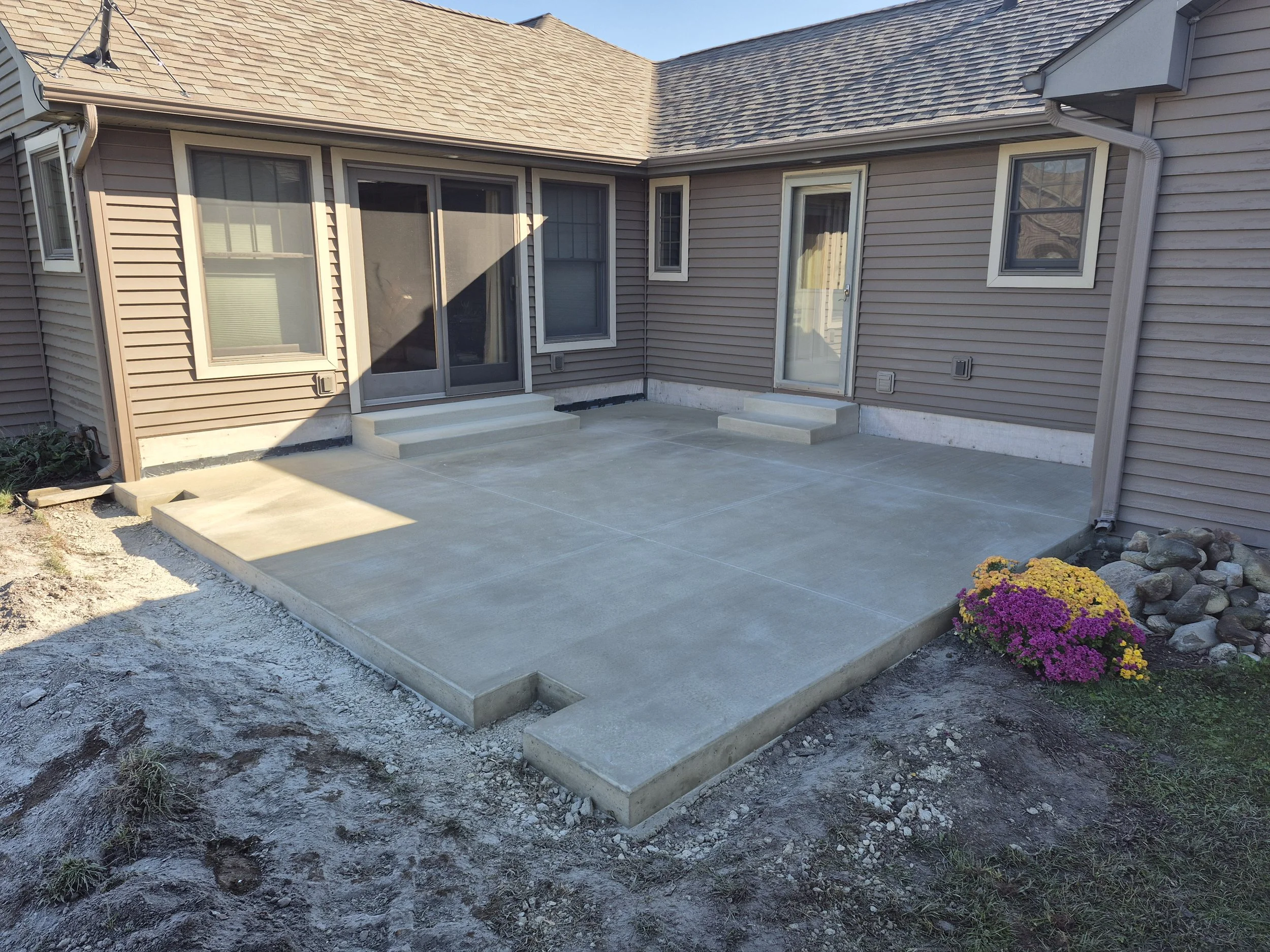 Professionally poured and installed patio concrete pad for residential property.
