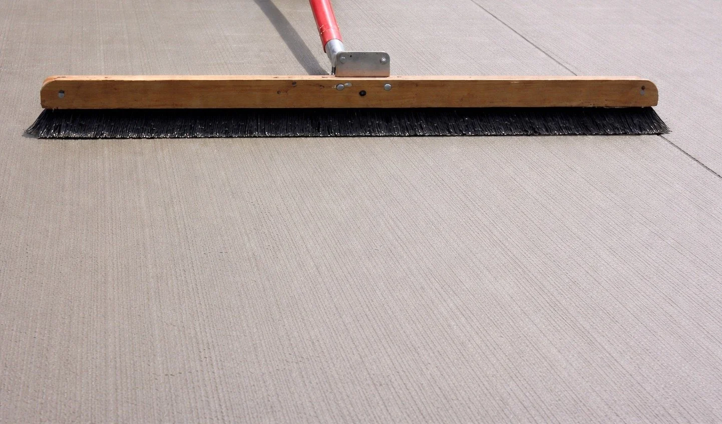 Final touch brushwork on quality concrete flatwork.