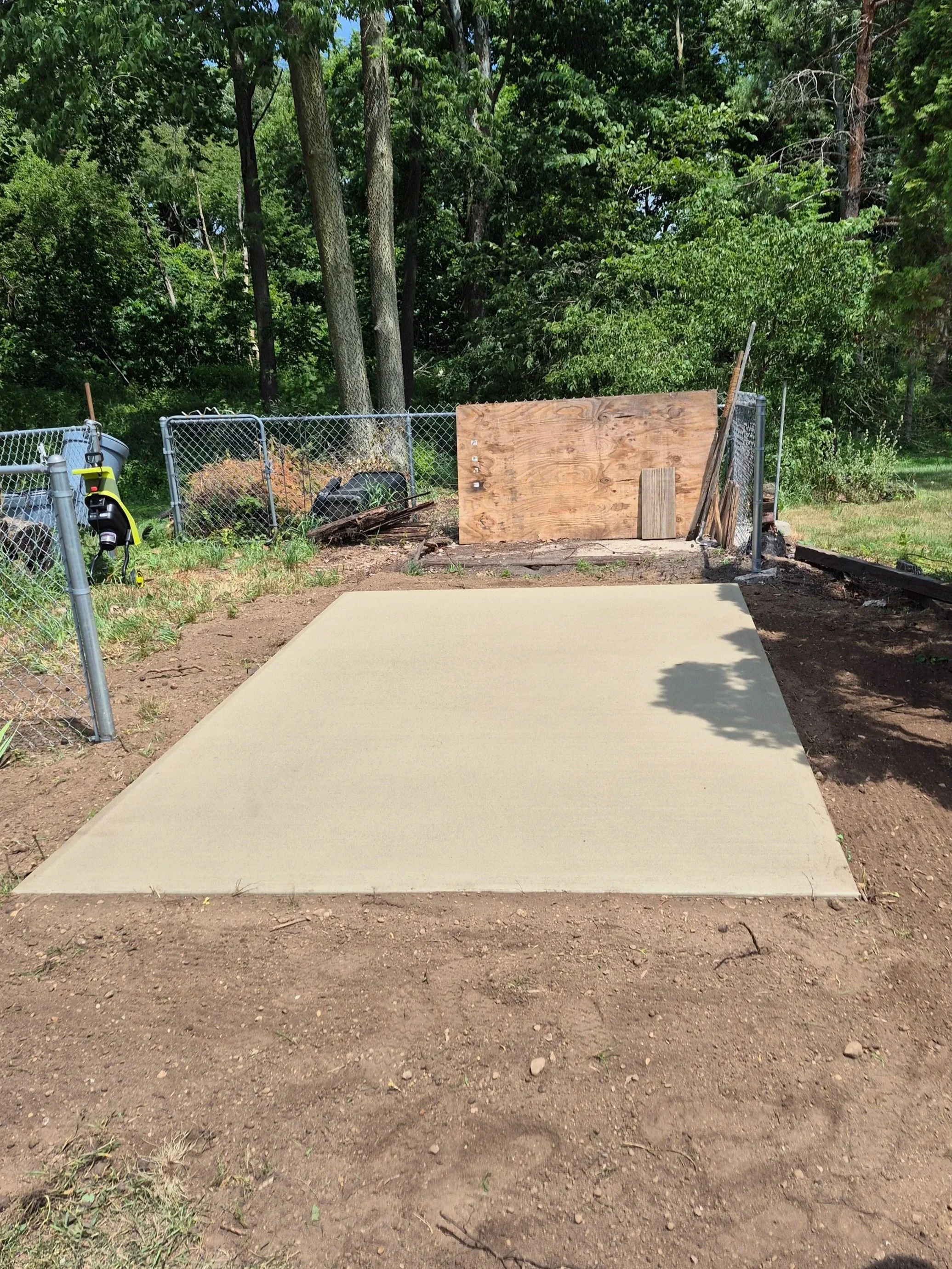 Professional concrete flatwork pad for small back yard shed.