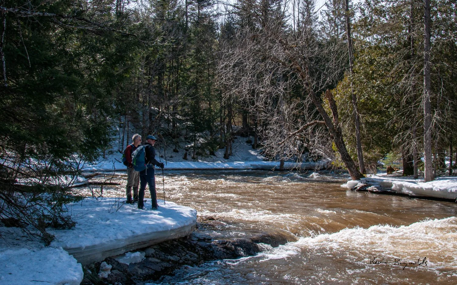 Using snowshoes to explore a spring creek