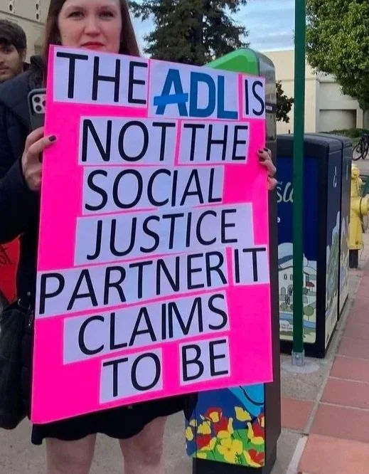 Protest sign says, "The ADL is not the social justice partner it claims to be