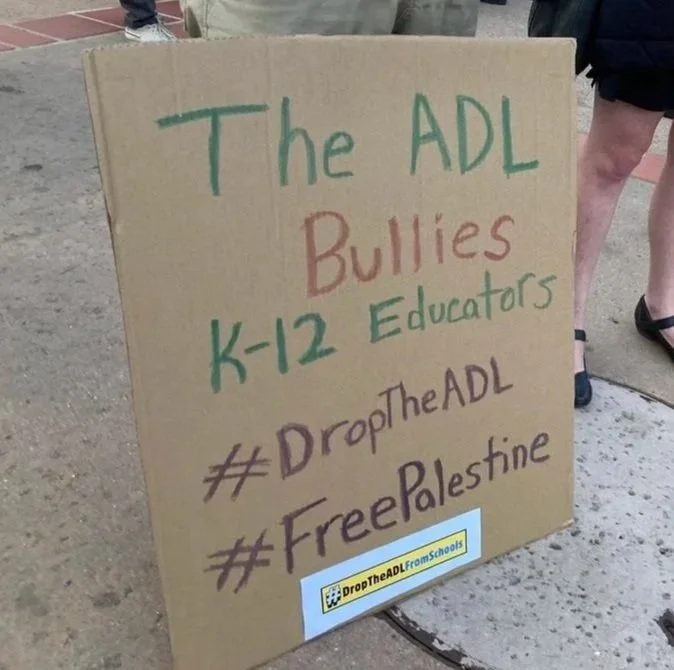 Protest sign: The ADL Bullies K-12 Educators