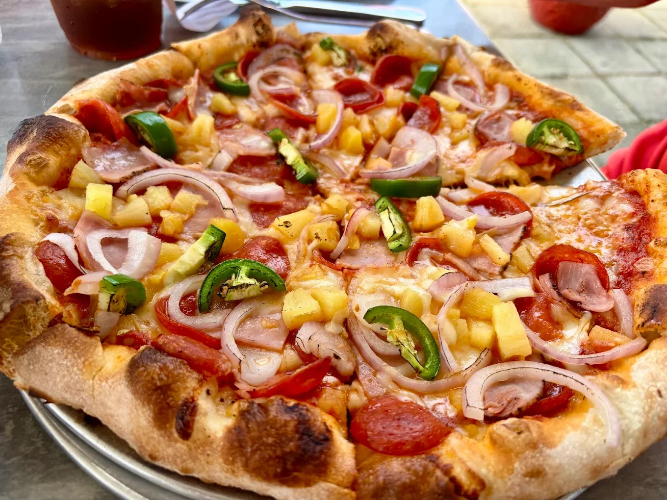 Photo of crisp wood fired pizza with custom toppings