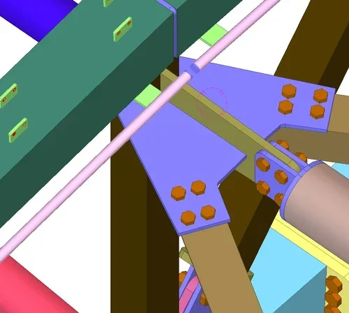 Close-up view of a mechanical or industrial assembly line with interconnected parts and orange nuts or bolts.