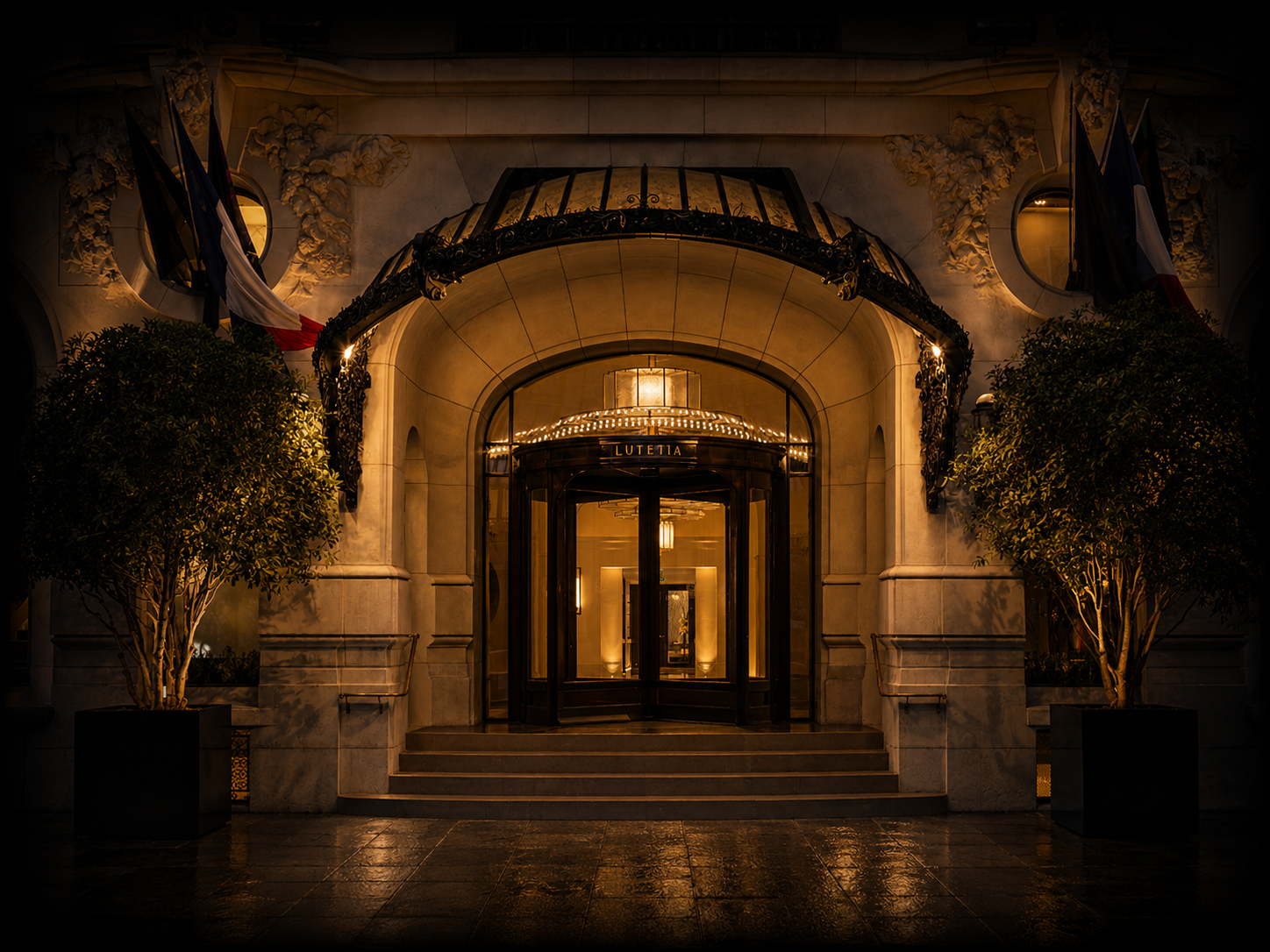 Entrée d'hôtel illuminée la nuit avec lampes et drapeaux, portant le nom 'Lutetia'.