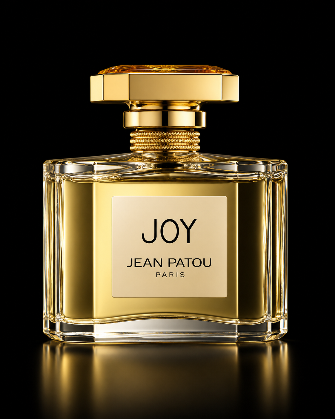Une bouteille de parfum dorée avec une étiquette indiquant 'Joy Jean Patou Paris' sur un fond noir