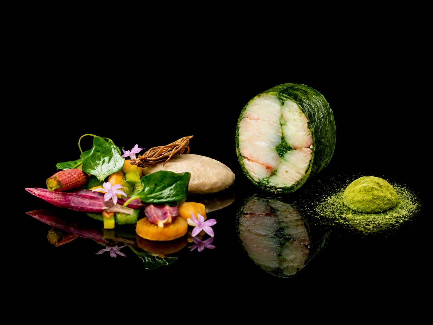 Assortiment de plats de sushi et de légumes décoratifs, avec un rouleau de sushi coupé, de la poudre de matcha et des fleurs violettes