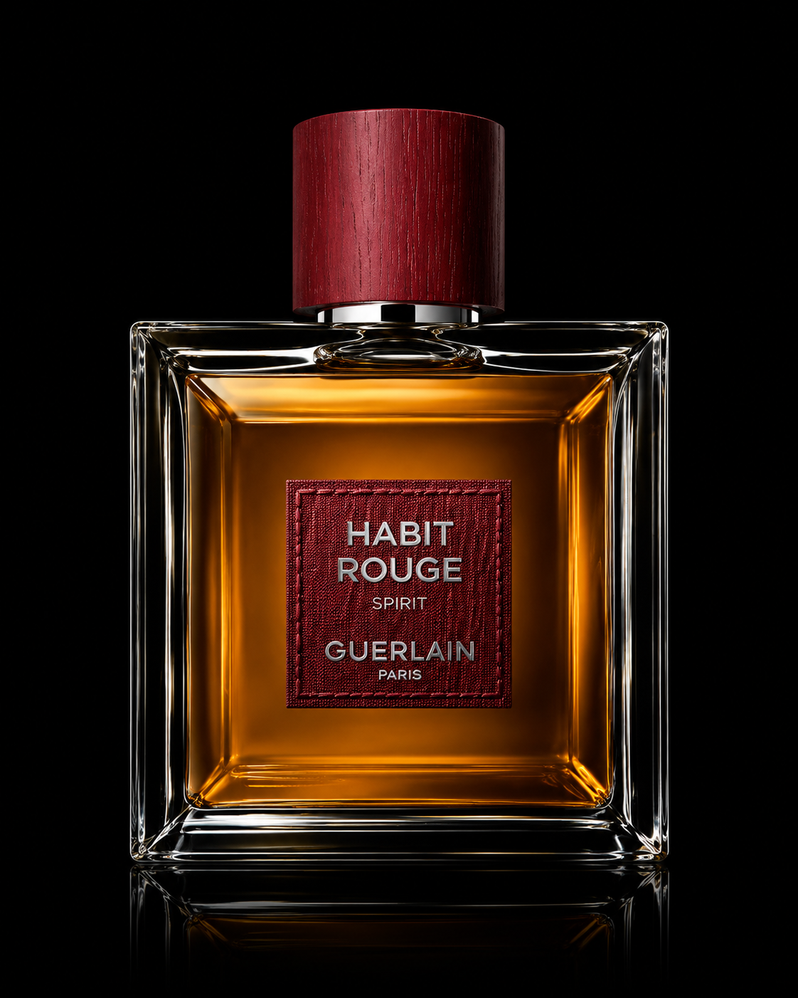 Flacon de parfum Guerlain 'Habit Rouge Spirit' avec étiquette rouge et bouchon en bois foncé.