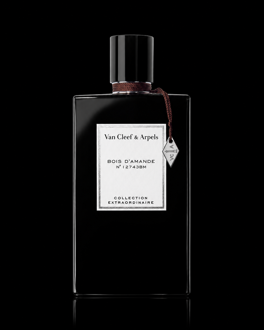 Flacon de parfum noir de la marque Van Cleef & Arpels avec étiquette blanche, posé sur un fond noir.