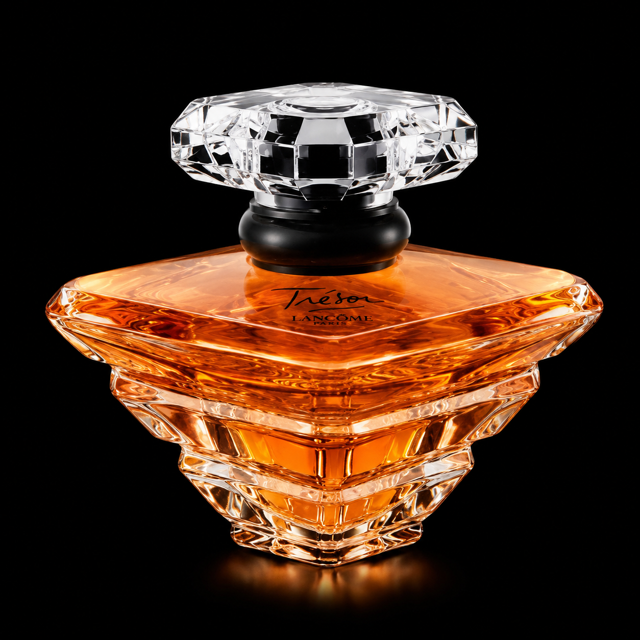 Un flacon de parfum en verre avec un liquide orange, portant l'inscription "Trésor" et "Lancôme".