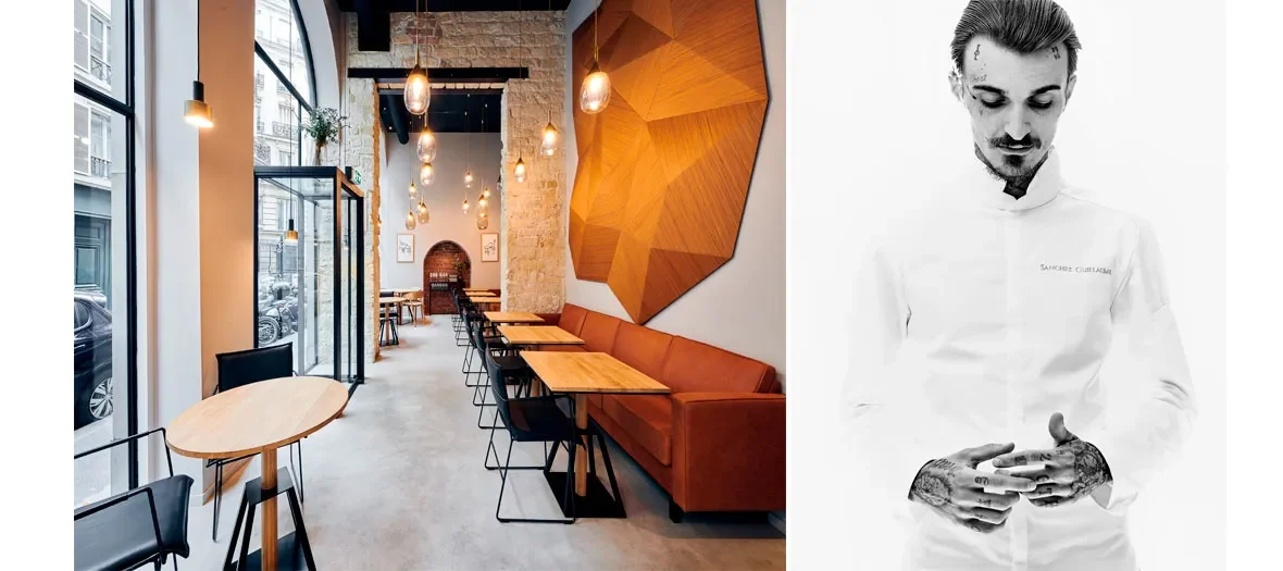 Intérieur moderne d'un café ou restaurant avec fenêtres grandes laissant passer la lumière, murs en briques et décoration en bois, tables en bois et sièges en cuir orange.