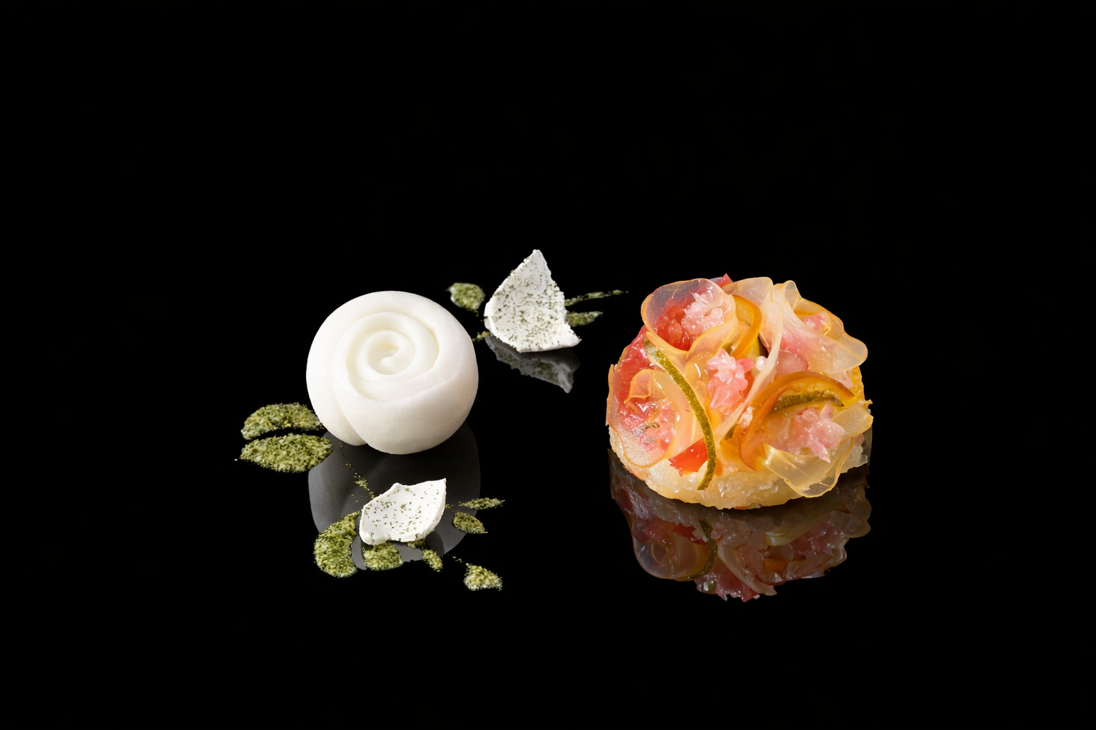 Gourmet plat presentation on a black reflective surface, featuring a colorful sculpture of thinly sliced vegetables and seafood and a white spherical sculpture, garnished with green herbs and white decorative elements.
