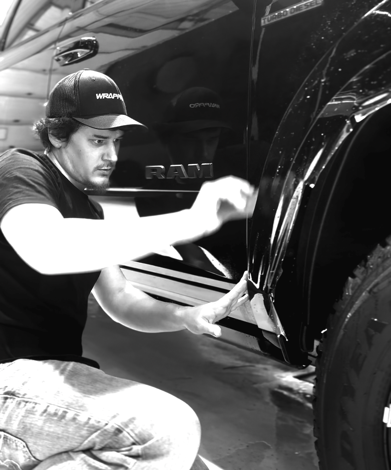 Man installing PPF Paint Protection Film on a Dodge Ram