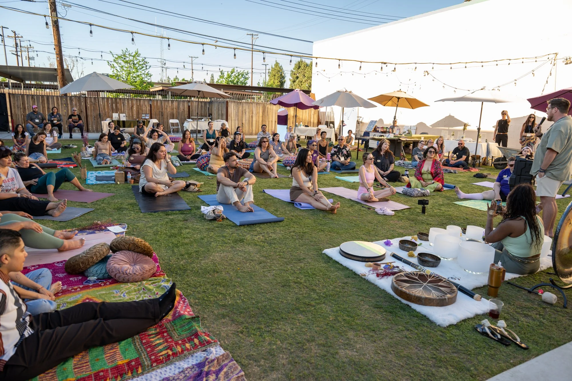 Community sound bath and embodied yoga practice at a Wayfinding Collective Soul Fair gathering in Bakersfield, California