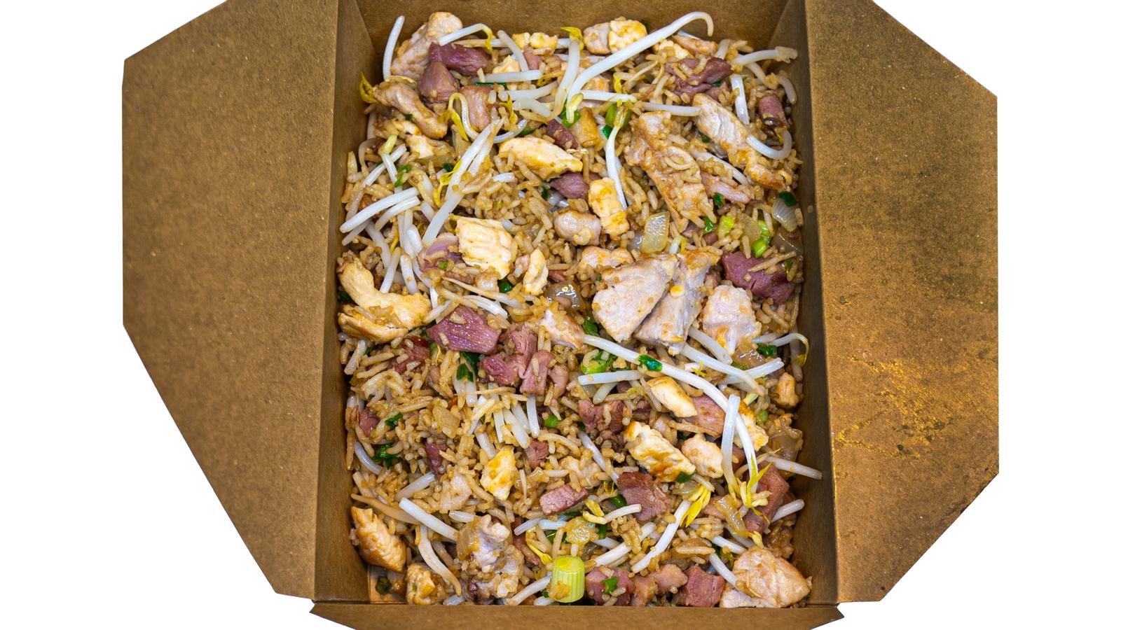 Container of fried rice with chicken, bean sprouts, diced ham, and chopped green onions.