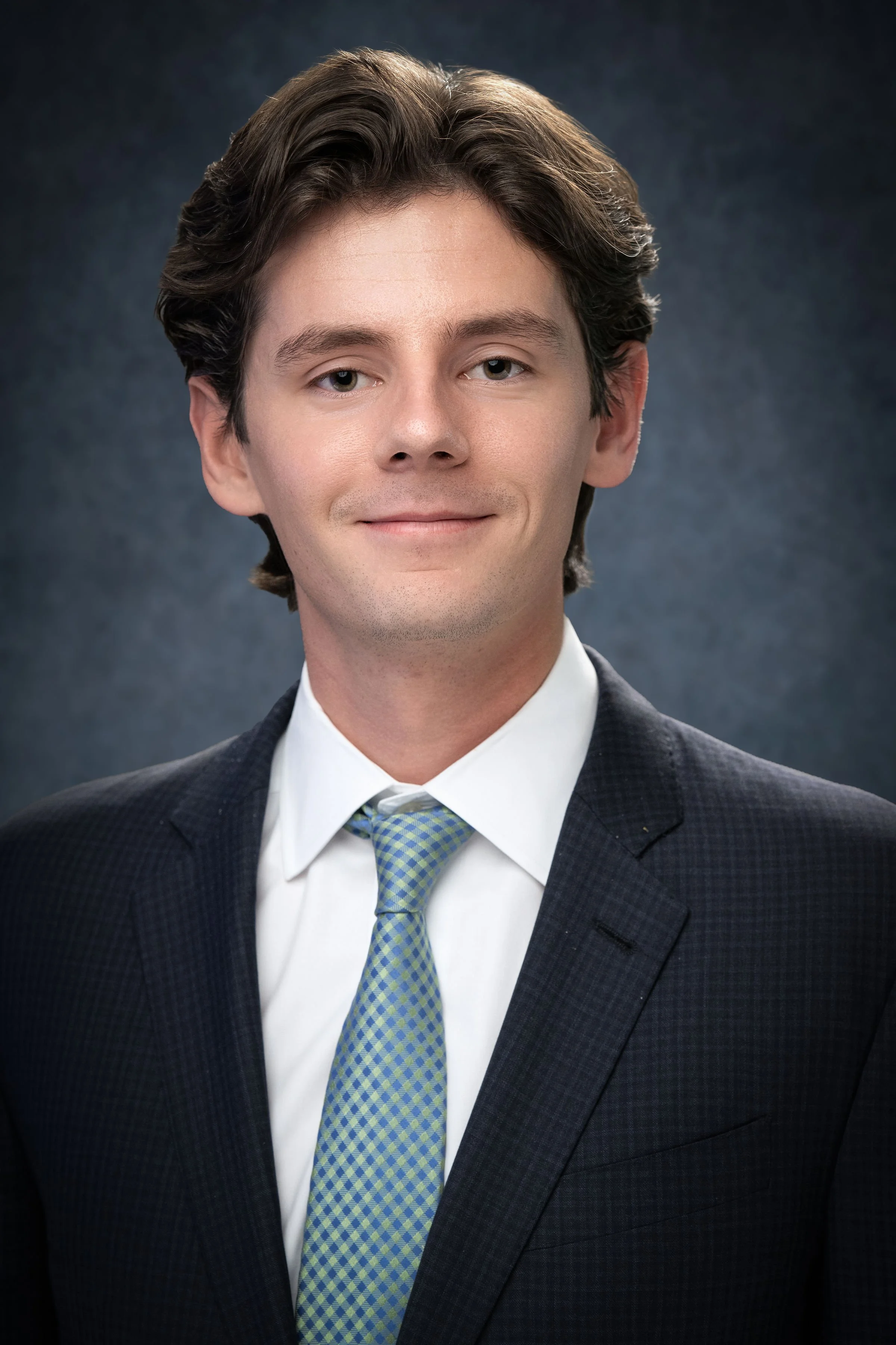 Studio corporate headshot reflecting professionalism, consistency, and a strong executive presence.