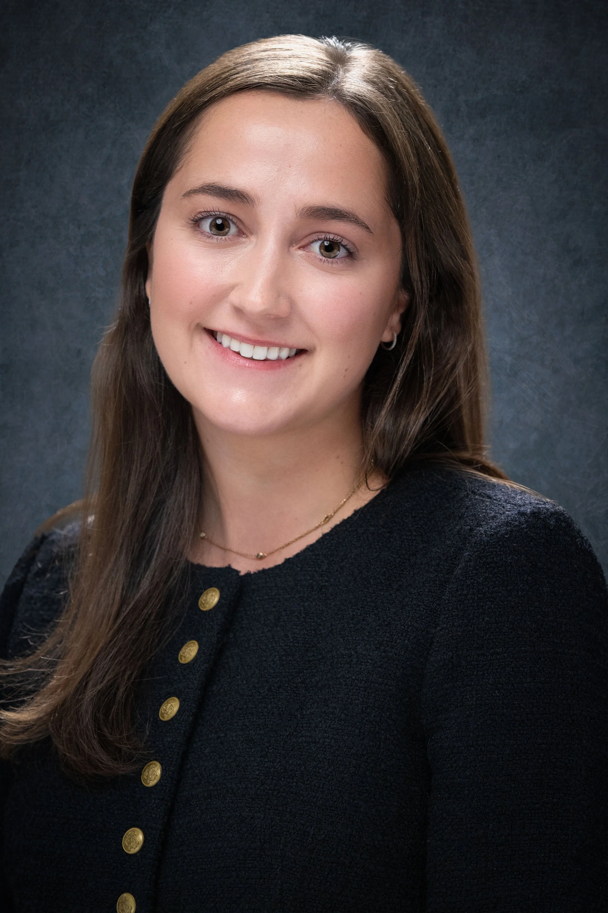 Studio headshot of a business professional with a confident yet approachable expression, designed for professional use.