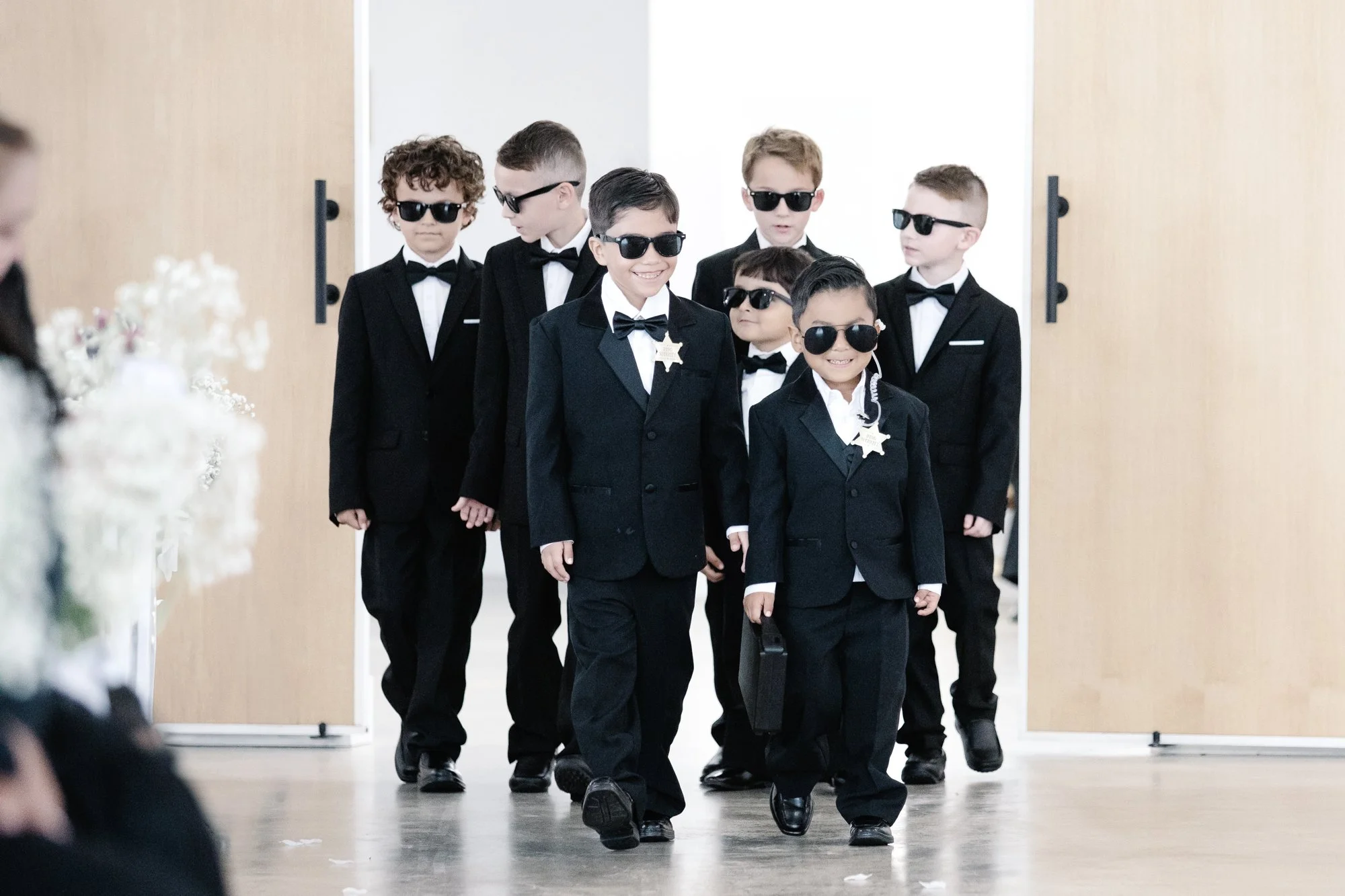Wedding boys walking in suits with sunglasses fun ceremony entrance moment