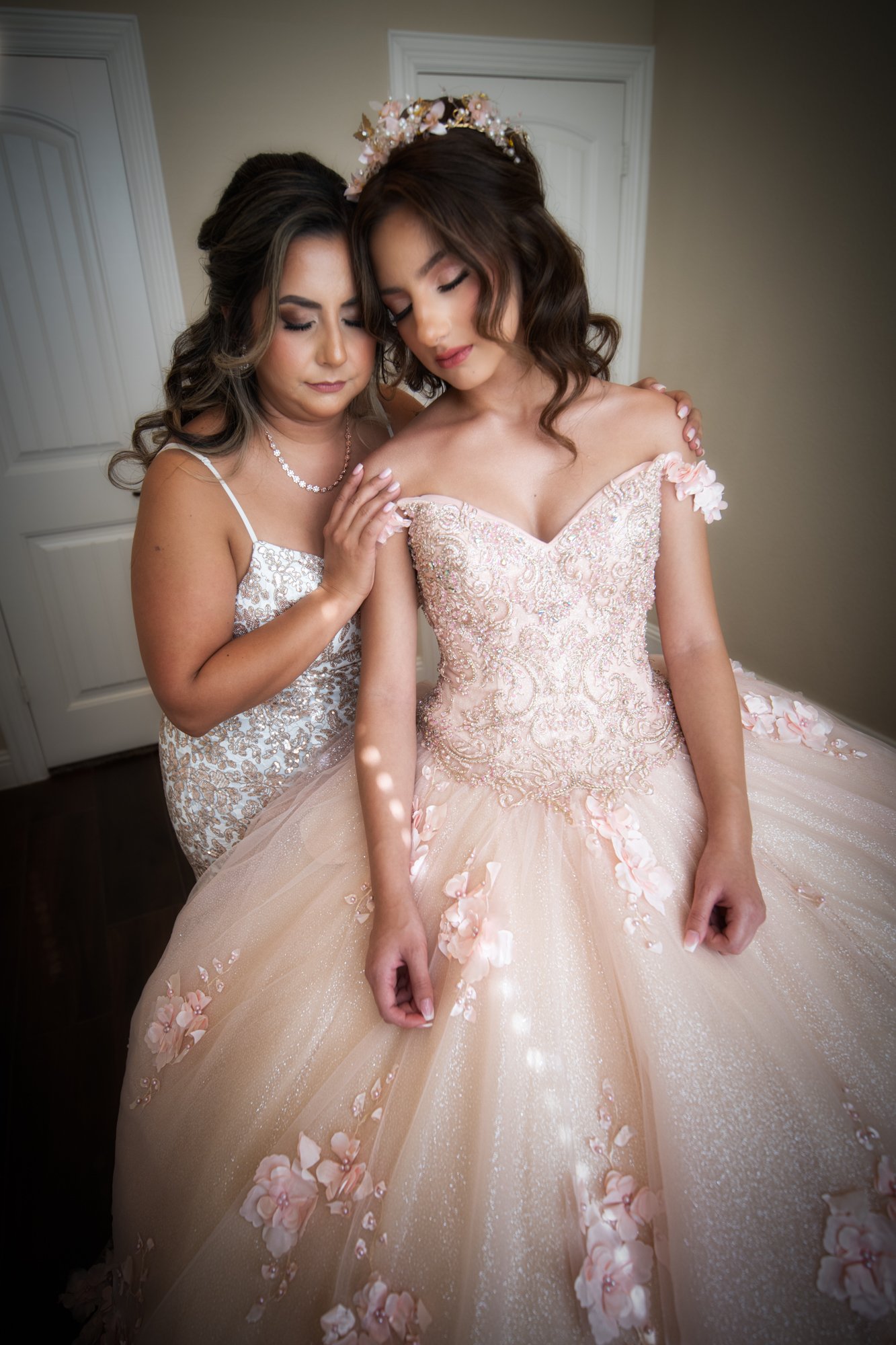 A deeply emotional portrait of mom and daughter sharing a quiet connection. Eyes closed, foreheads near, and hands gently placed, it’s a timeless moment symbolizing love, pride, and transition.