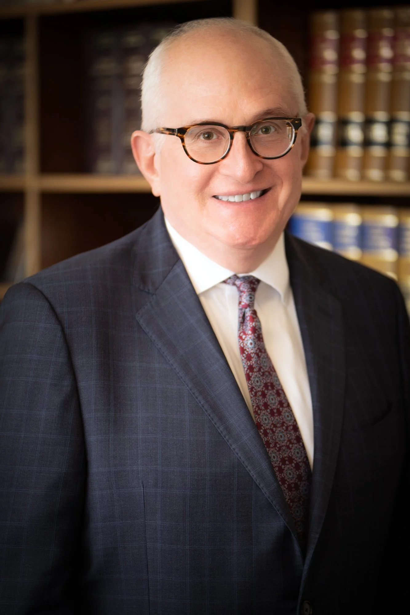 Executive headshot with a polished, professional aesthetic, ideal for high-level business profiles.