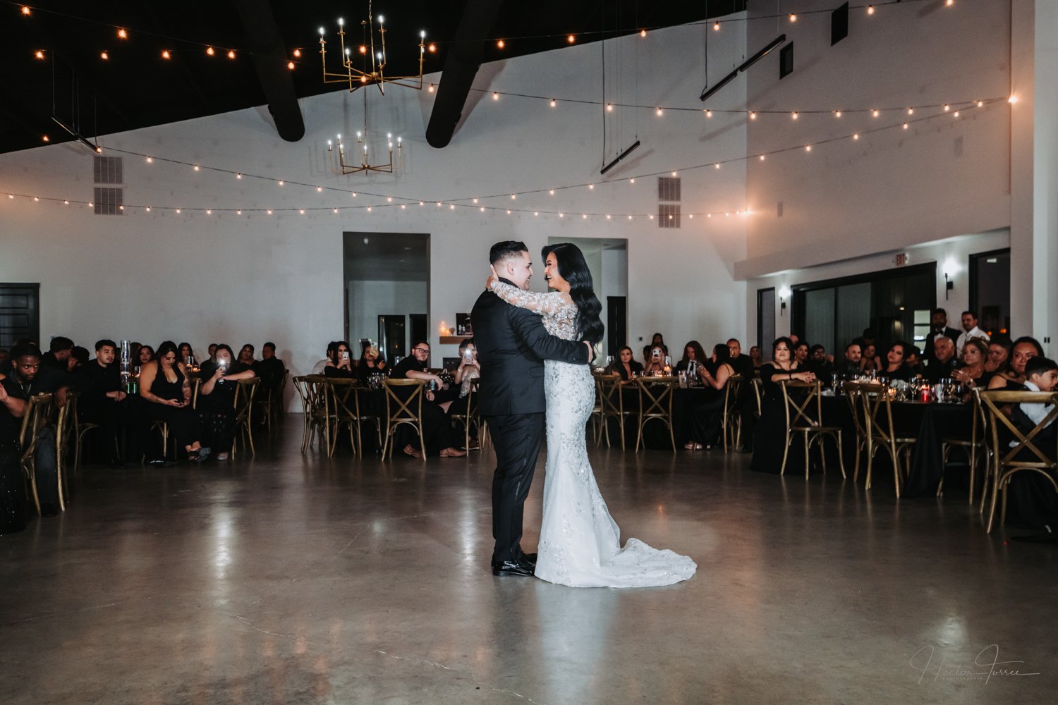 Karen and Matthew share their first dance surrounded by family and friends during their elegant wedding reception in Texas, photographed by Hector Torres Photography.