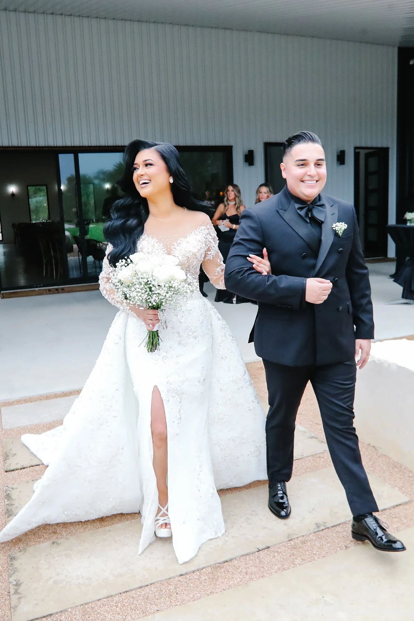 The newlyweds walk arm in arm immediately after their ceremony, smiling with pure joy as they take in the love and congratulations from their guests.
