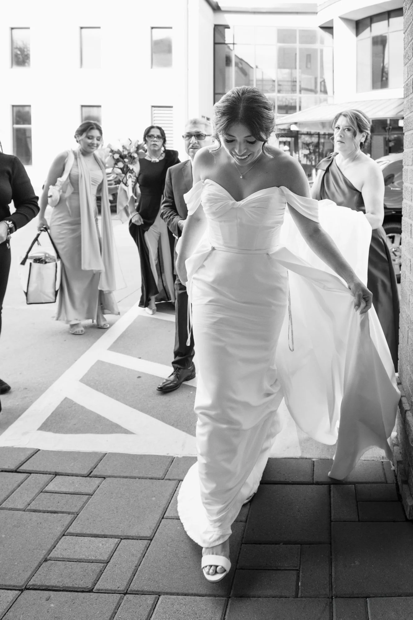 Briseida and Sergio share a romantic wedding portrait inside their modern Dallas wedding venue, framed by floor-to-ceiling windows and elegant architecture.