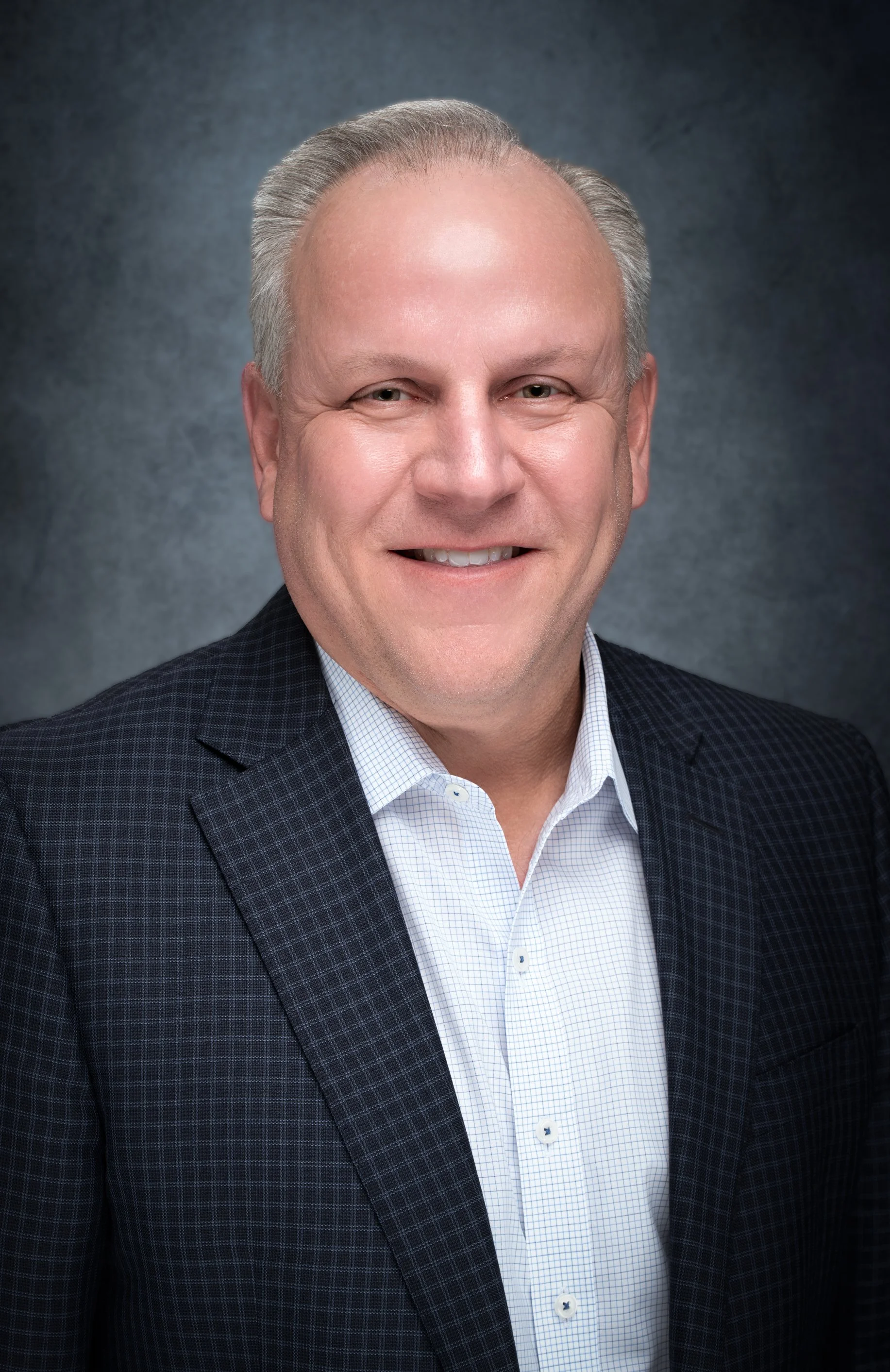 Professional headshot designed for corporate branding, featuring precise lighting and a minimalist background for a modern business look.