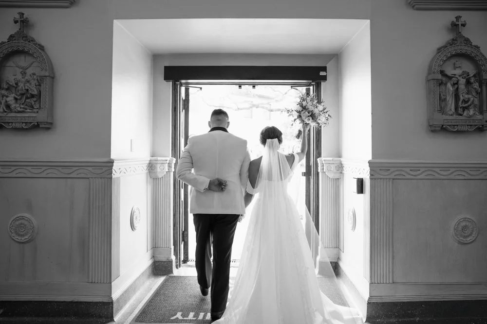 Newlywed bride and groom exiting a church after their wedding ceremony in Texas. This emotional wedding photography moment captures the joy, love, and excitement of the couple's first steps together as husband and wife. Professional wedding photograp