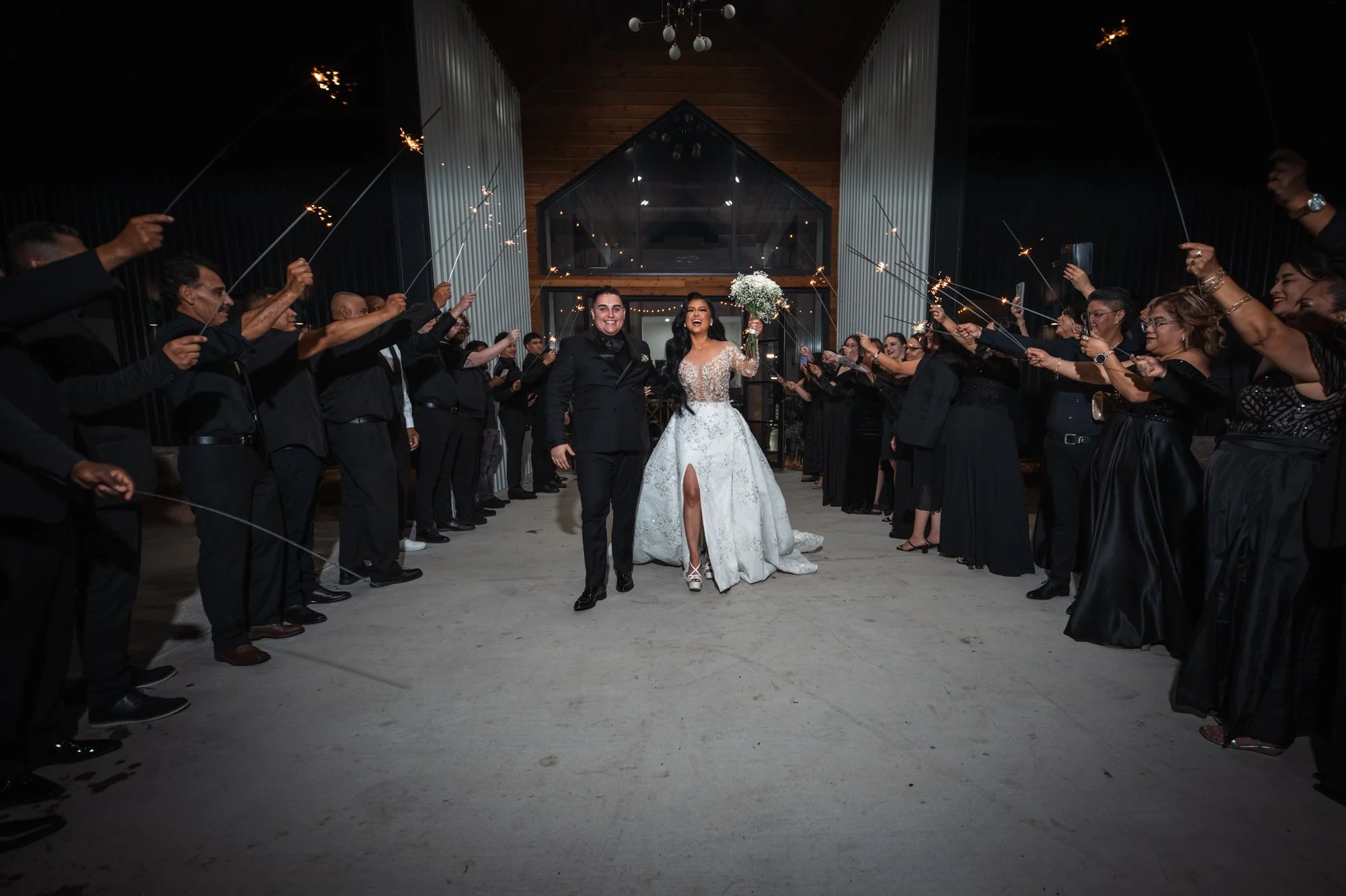 Karen and Matthew celebrate their sparkler exit surrounded by family and friends as they conclude their wedding day in Dallas, Texas.