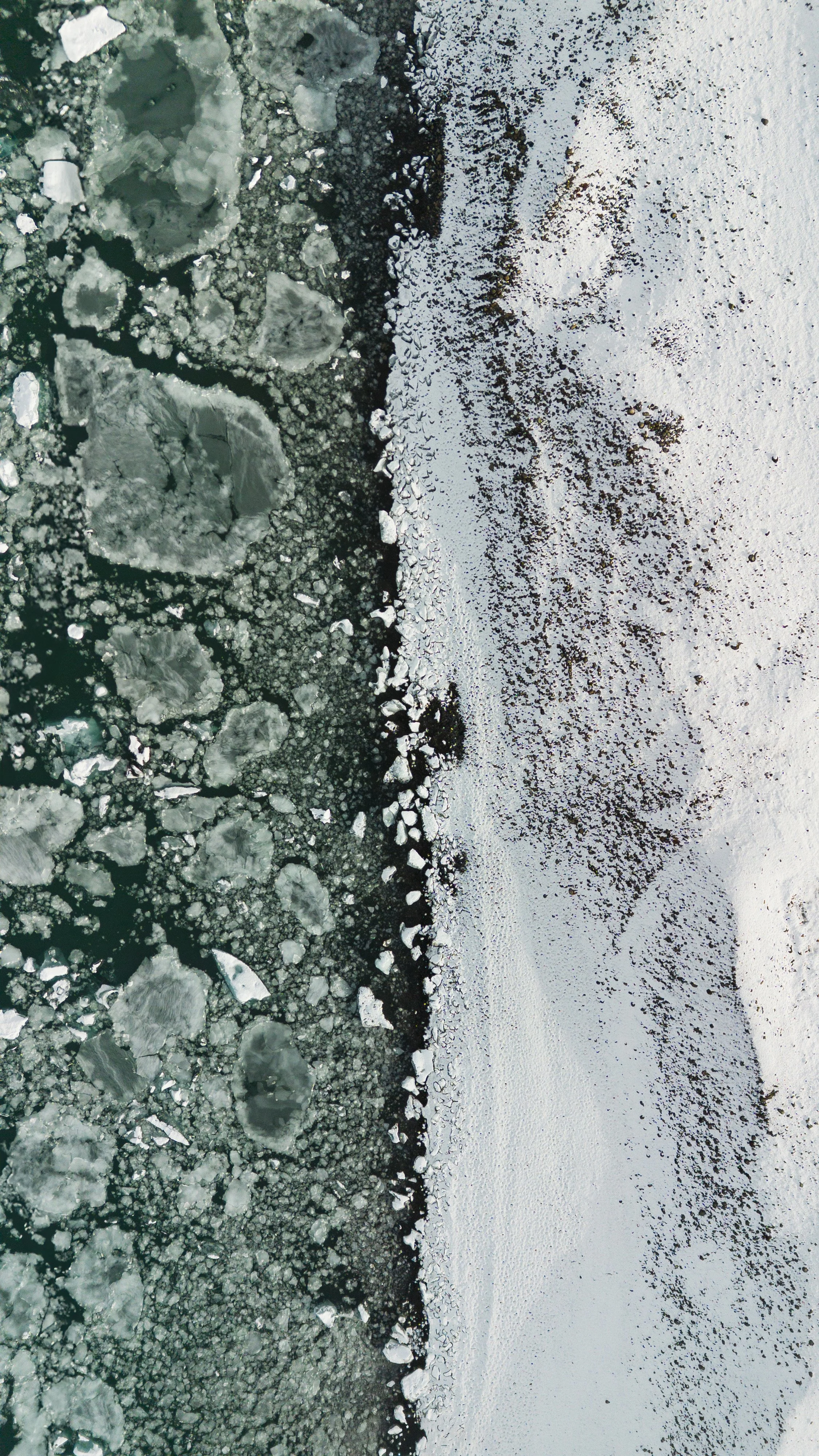 Frozen lake with ice chunks and snow on the surface