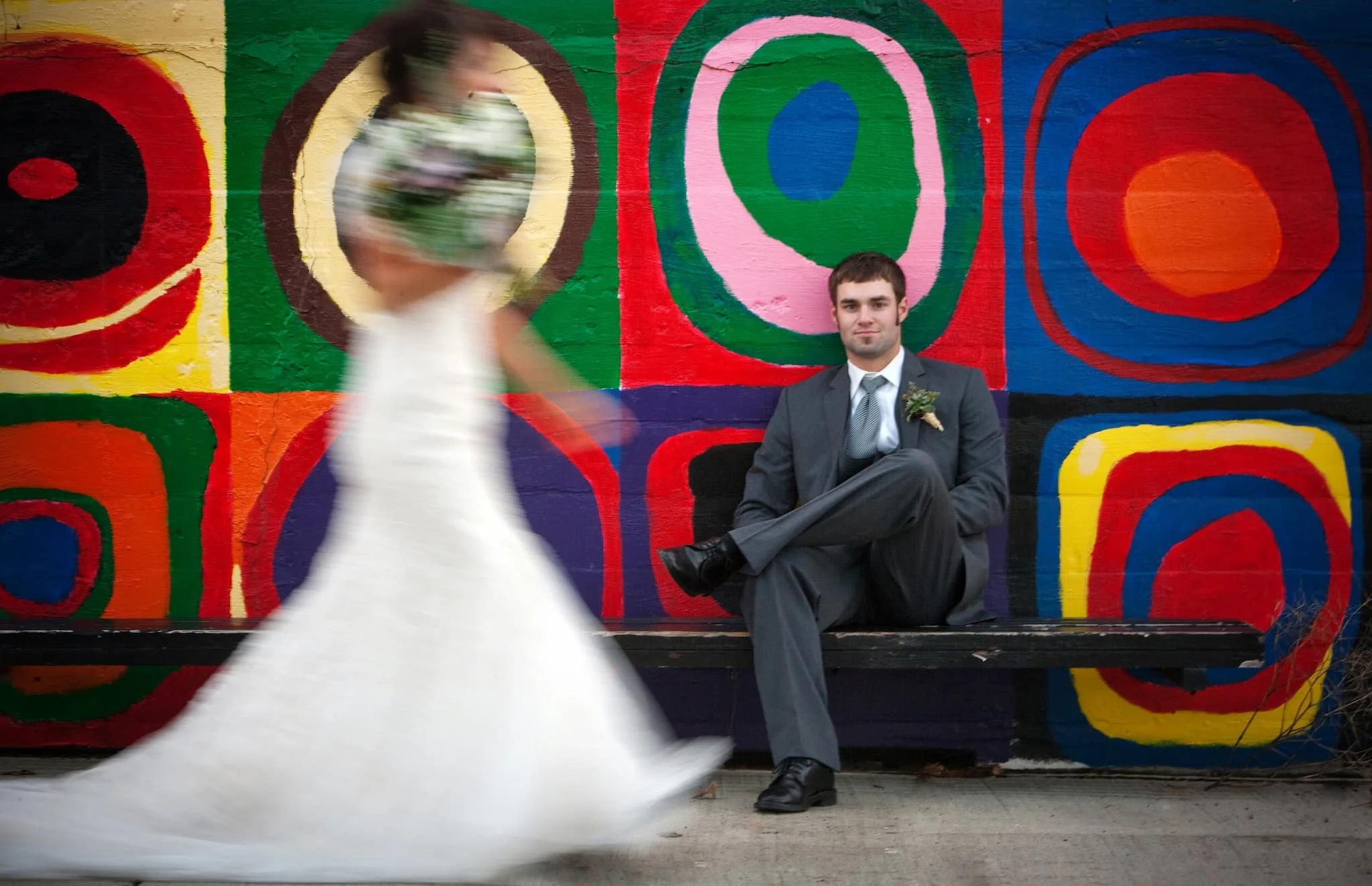 Artistic groom portrait highlighting tailored details, masculine styling, and authentic emotion, as the bride walks, photographed in a refined storytelling style for San Antonio couples.