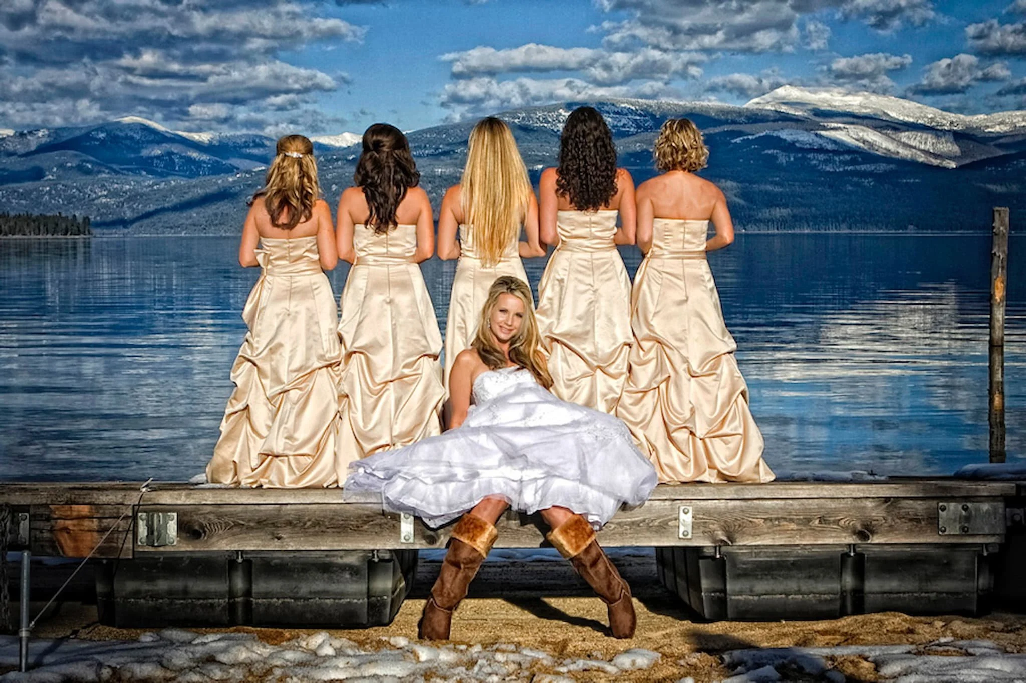 Bride posing with her bridesmaids in a creative, original arrangement, showcasing artistic composition and playful style.