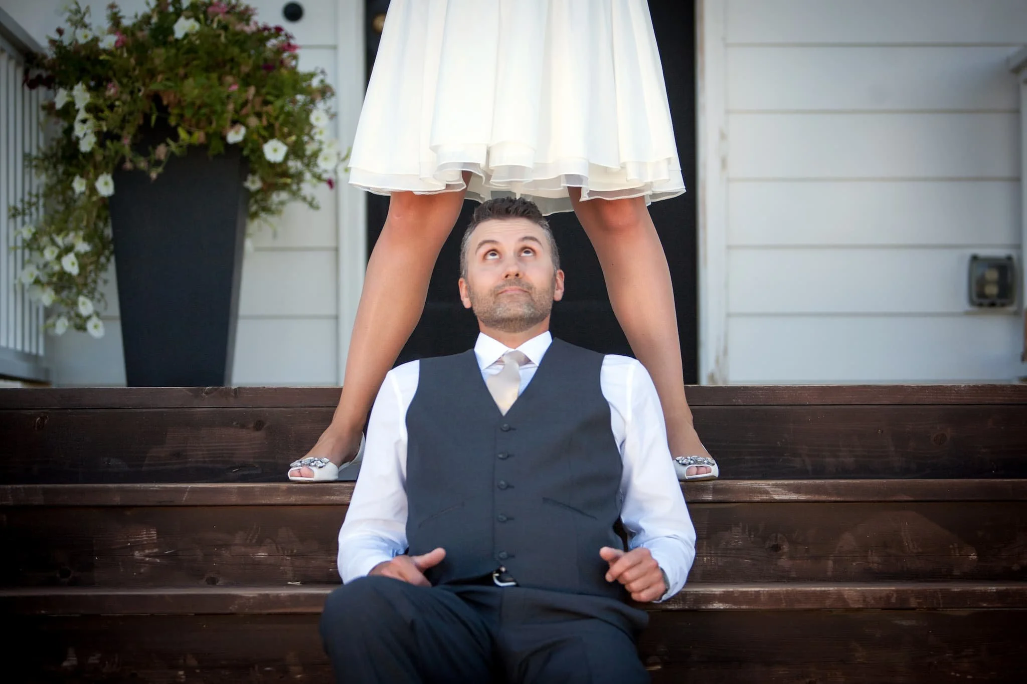Groom getting a good look at his bride, anticipating the events after the ceremony and reception, captured with artistic energy by this San Antonio photographer