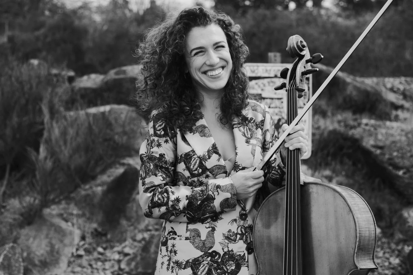 Cello teacher, Natalie Hall, smiling with cello, ready to give lessons