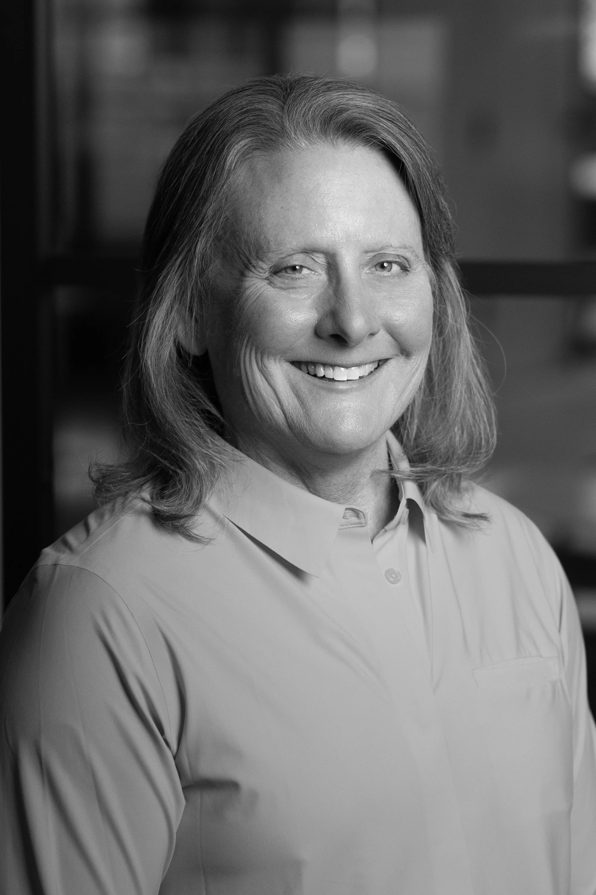 A black and white portrait of Gennifer Baker, Founder of EVP Leadership
