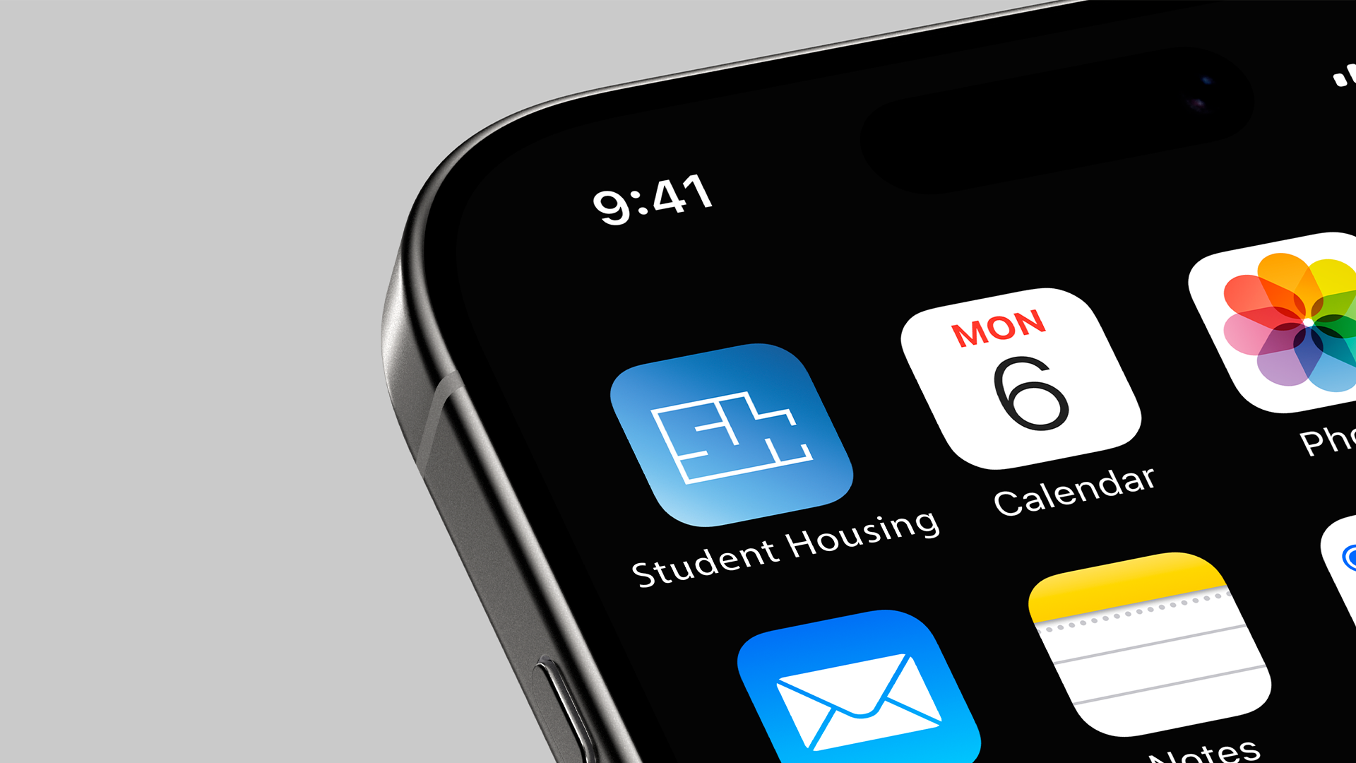 Close-up of a smartphone screen showing app icons, including Student Housing, Calendar, Photos, Mail, and Notes, with the time displayed as 9:41.