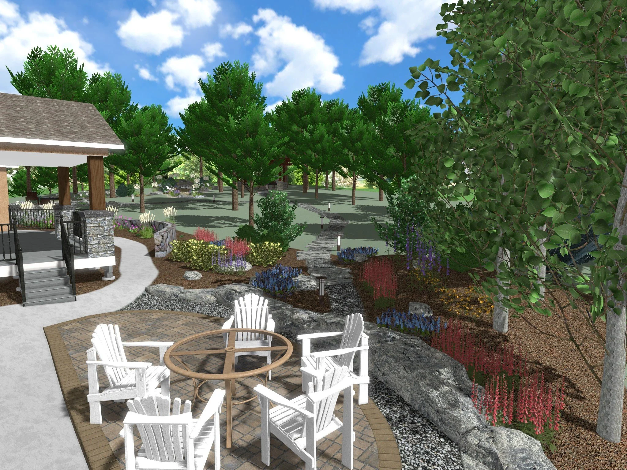 A landscaped garden scene with a patio area featuring white Adirondack chairs and a round table, paved with bricks, surrounded by lush trees, flowering plants, large rocks, a pavilion with steps, a curved walking path, and a blue sky with white clouds.