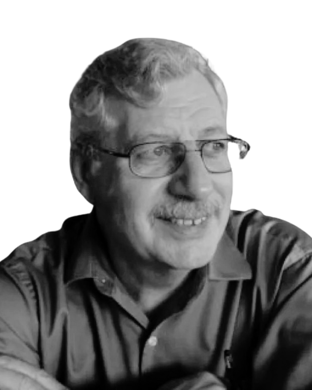 Black and white photo of an older man with glasses, smiling, wearing a button-up shirt with vertical stripes.